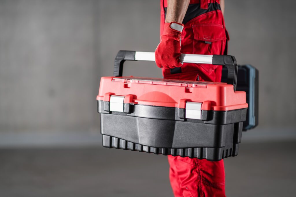 Repairman Home Call Concept with Handyman Holding His Toolbox.